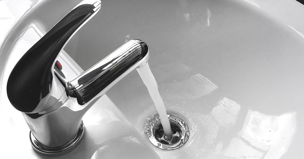 Hand-washing station [includes bucket with tap, bowl, and soapy water